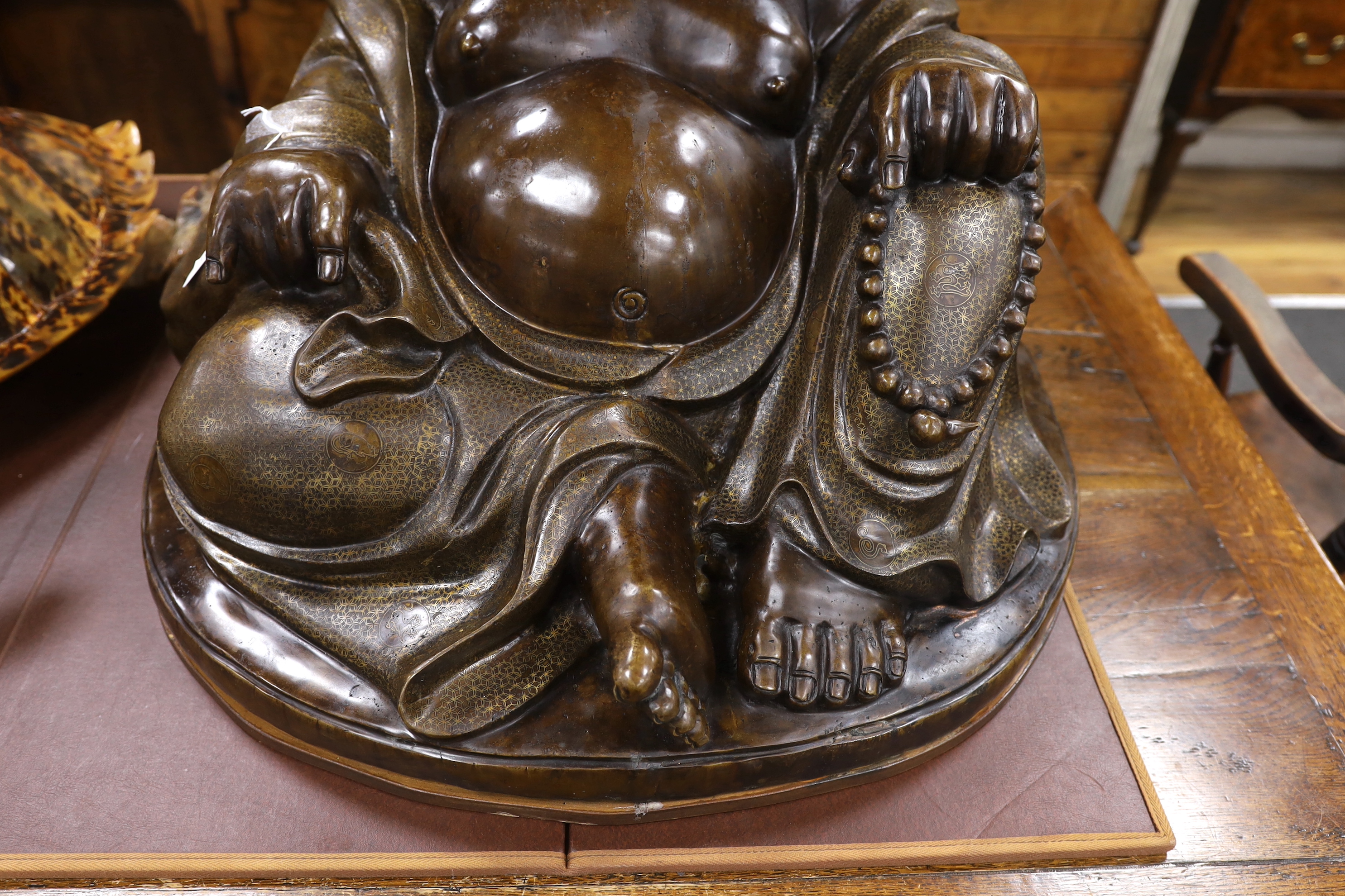 A massive Chinese bronze seated figure of Budai, 62cm high
